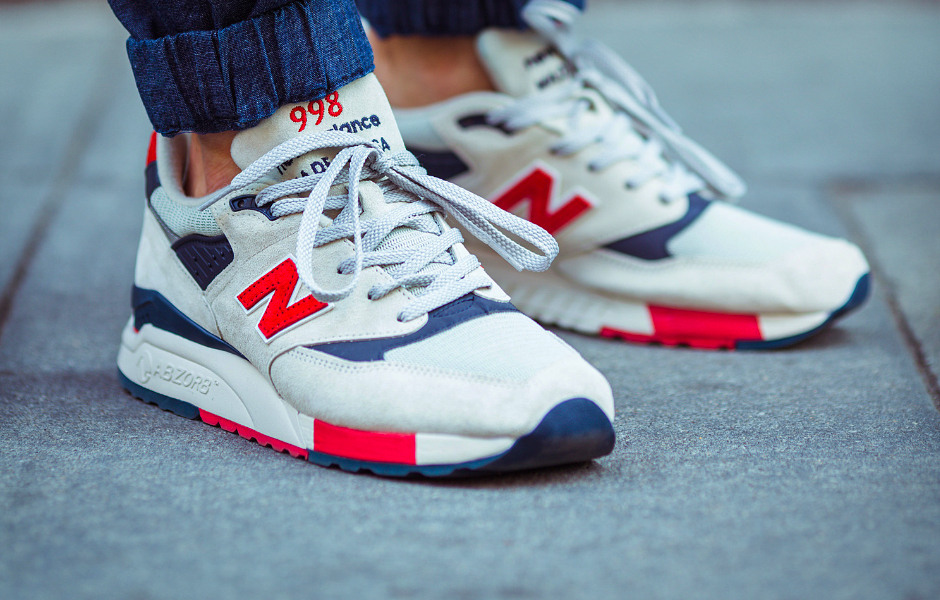 A pair of New Balance sneakers on a person.