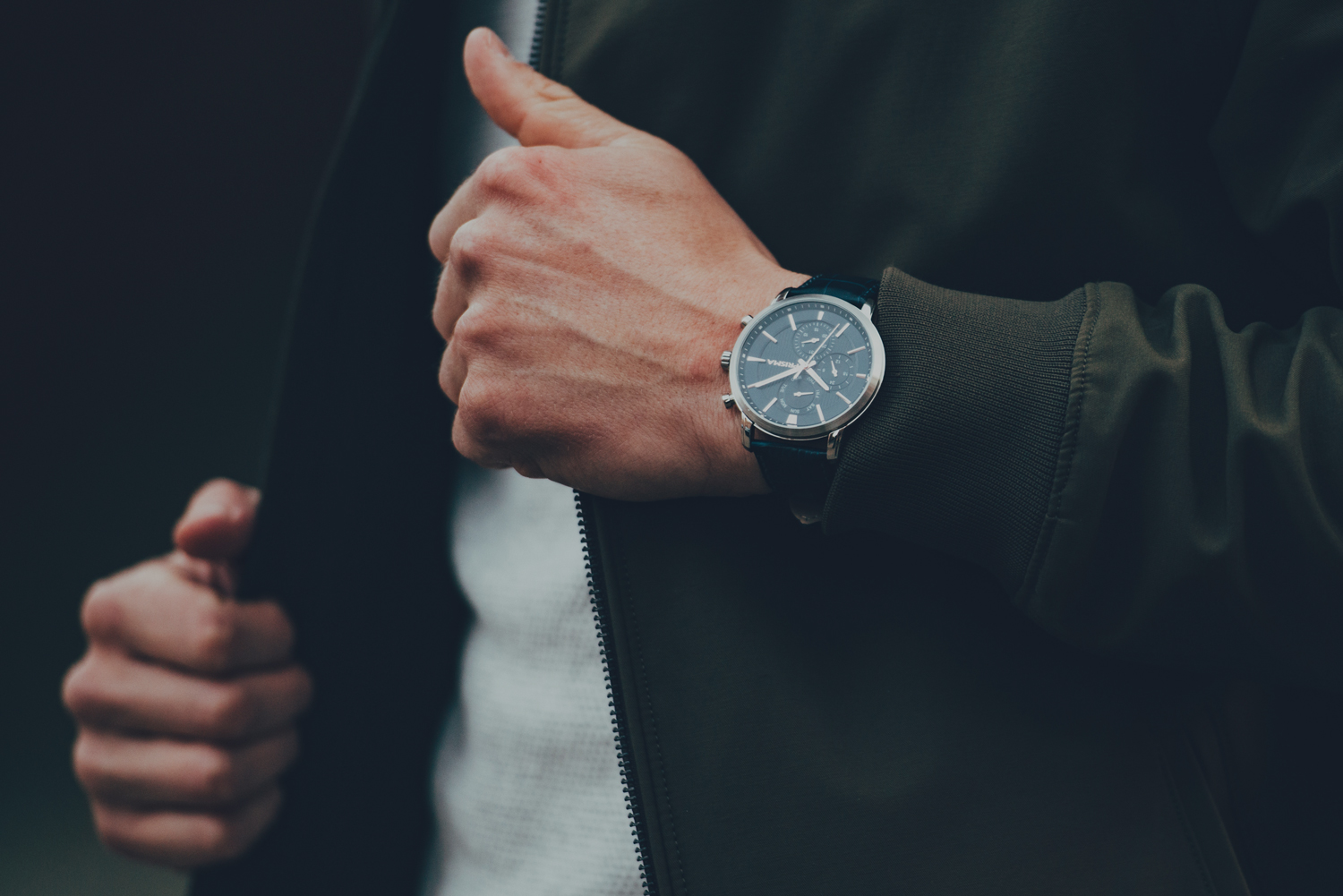 Man wearing jacket and watch