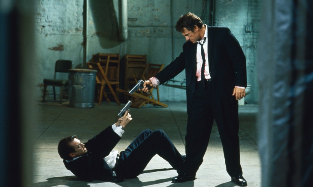 Harvey Keitel and Tim Roth point guns at each other in Reservoir Dogs