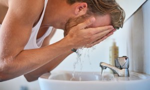 Man washing his face