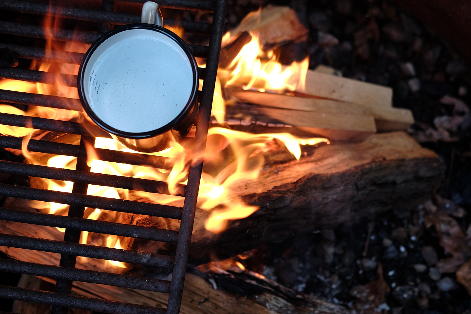 Boiling a cup of milk over a fire.