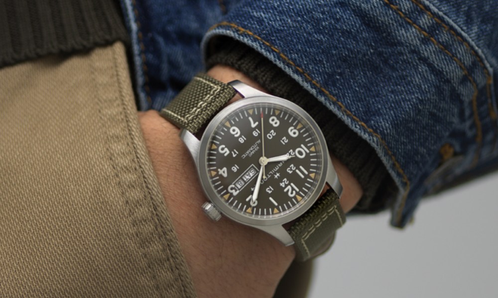 Close-up of a man wearing a field watch