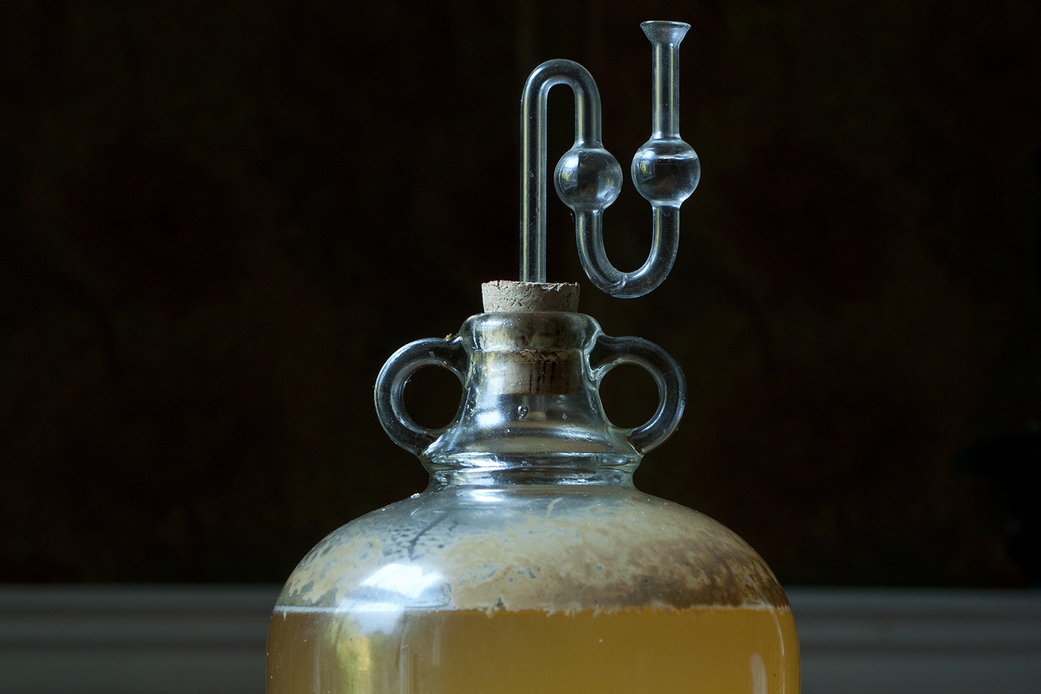 A large bottle of apple cider demijohn.