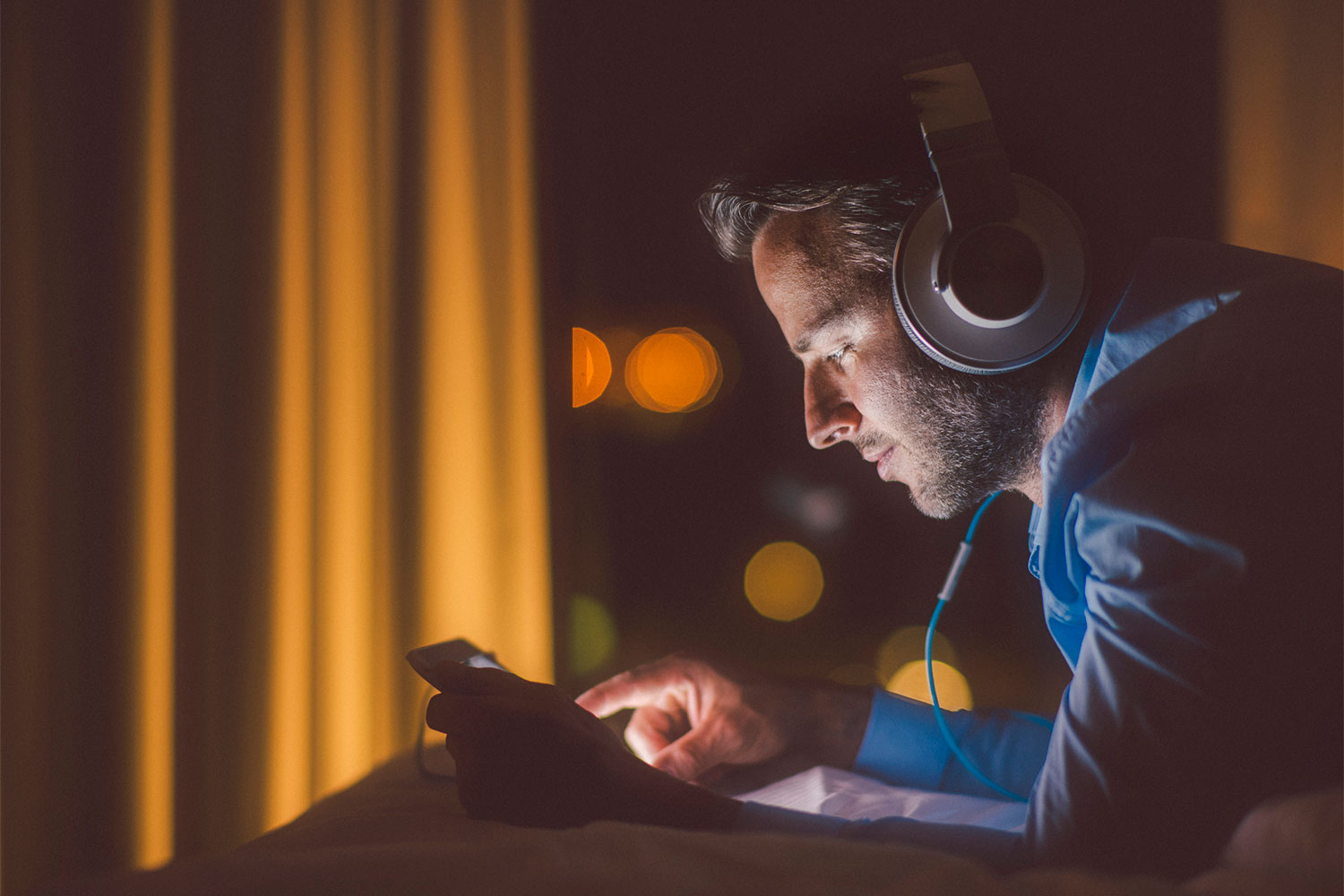 Man listening to a podcast with headphones