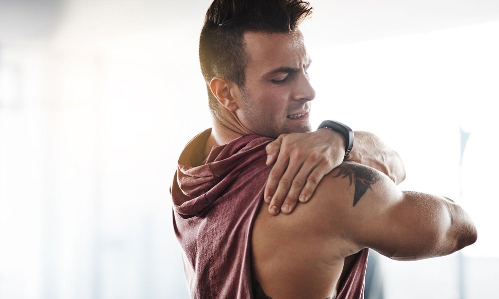 Man using muscle rub cream