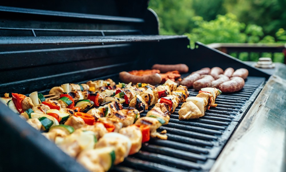 Veggies and meat on a gril.l