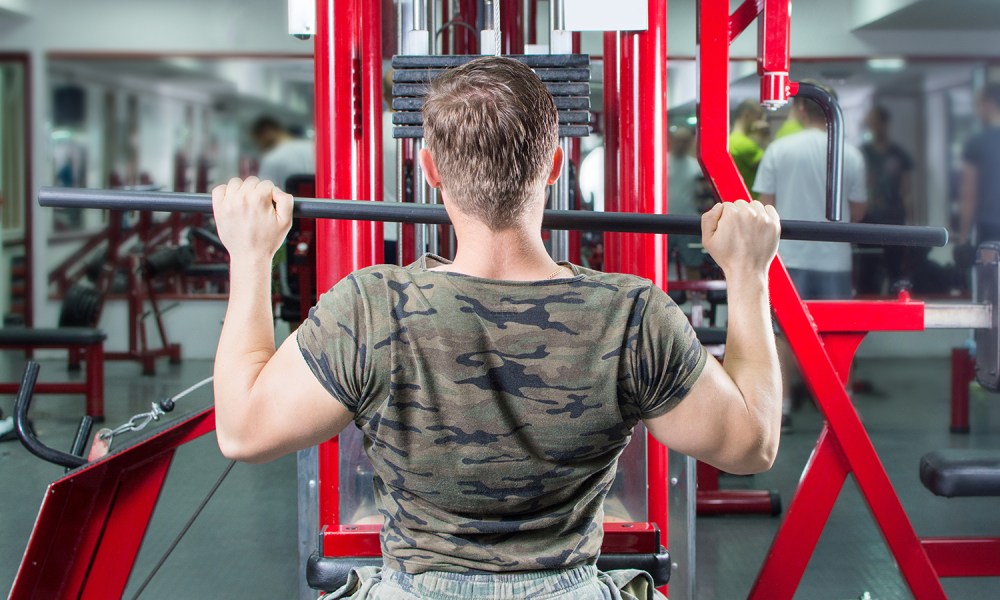 Man doing lat pull-downs close grip