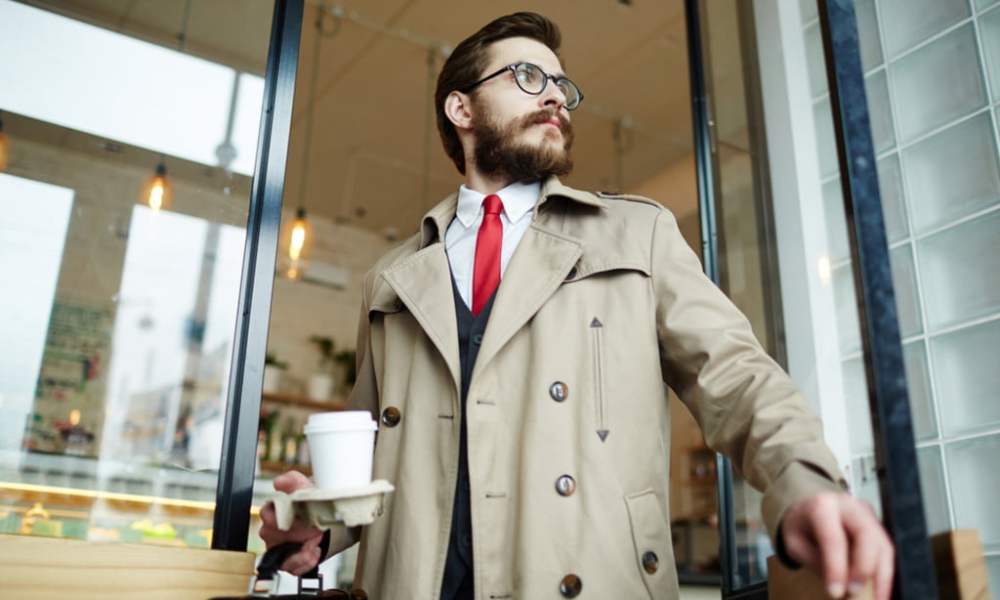 man in trench coat leaving coffee shop