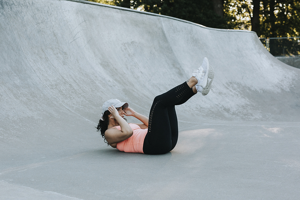 Woman doing double crunches.