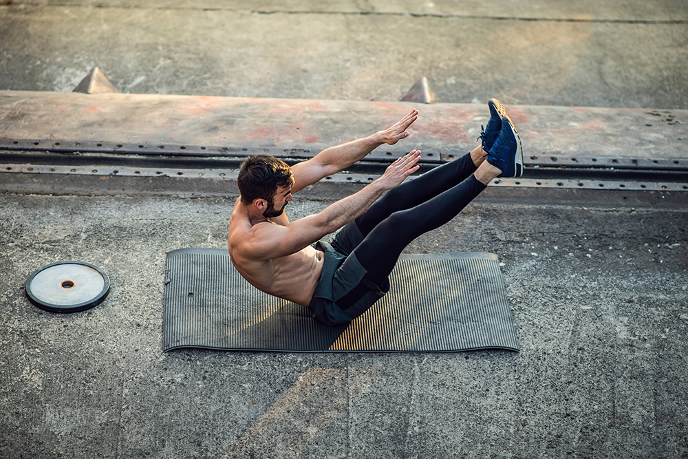 Man doing v sit exercise.