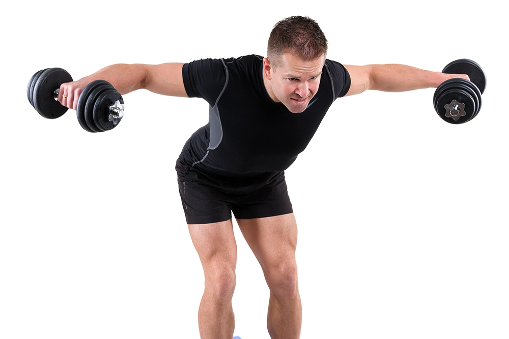 man doing a reverse fly with a white background using dumbbells 