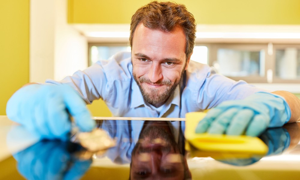 Man cleaning his stovetop