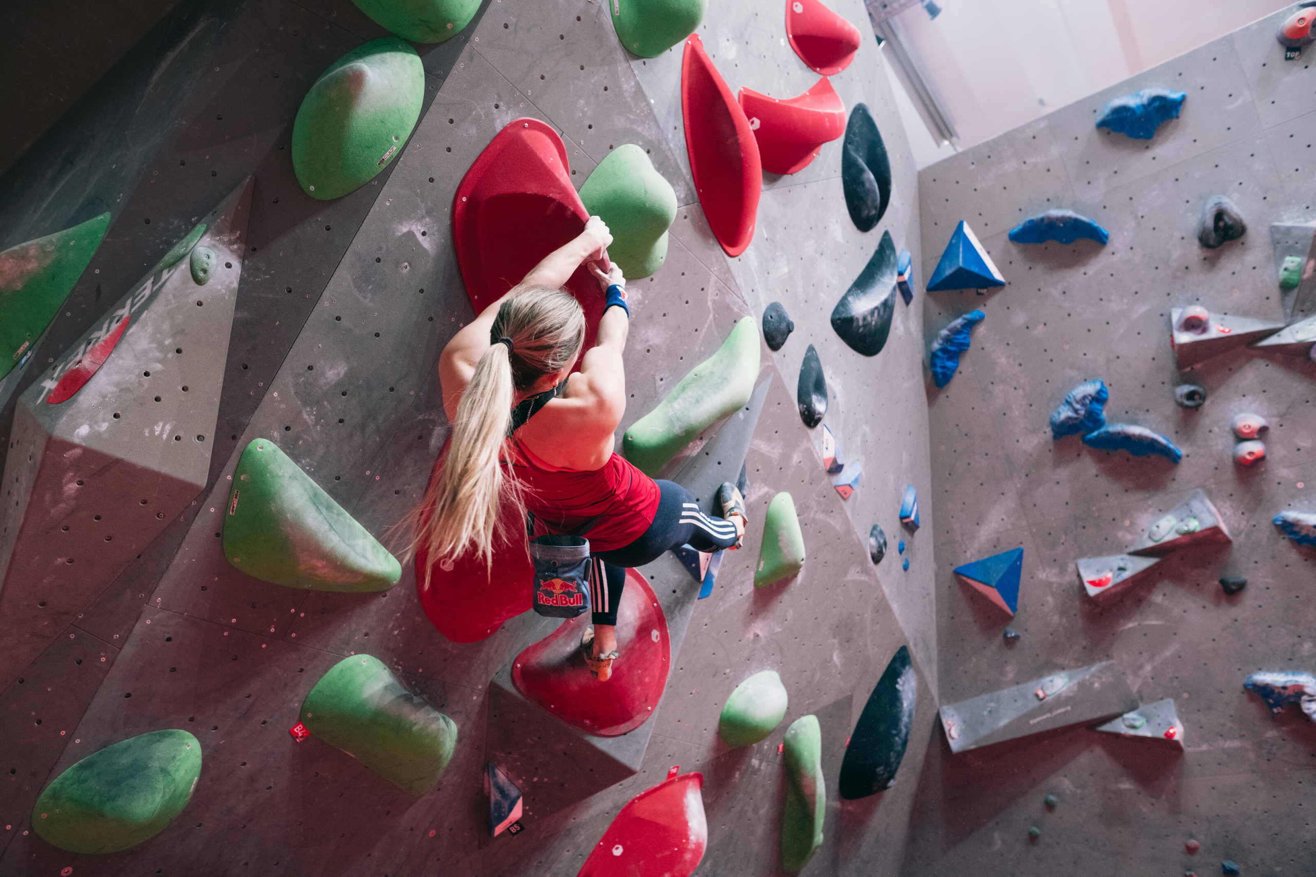 Woman doing the climbing wall inside