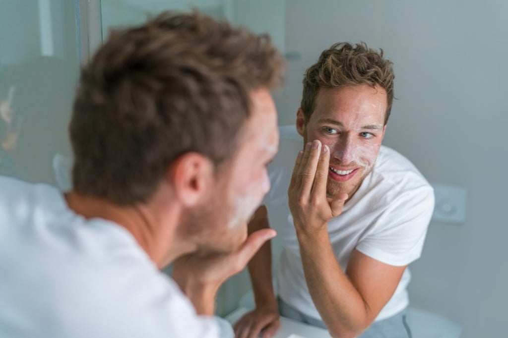 Man exfoliating his skin