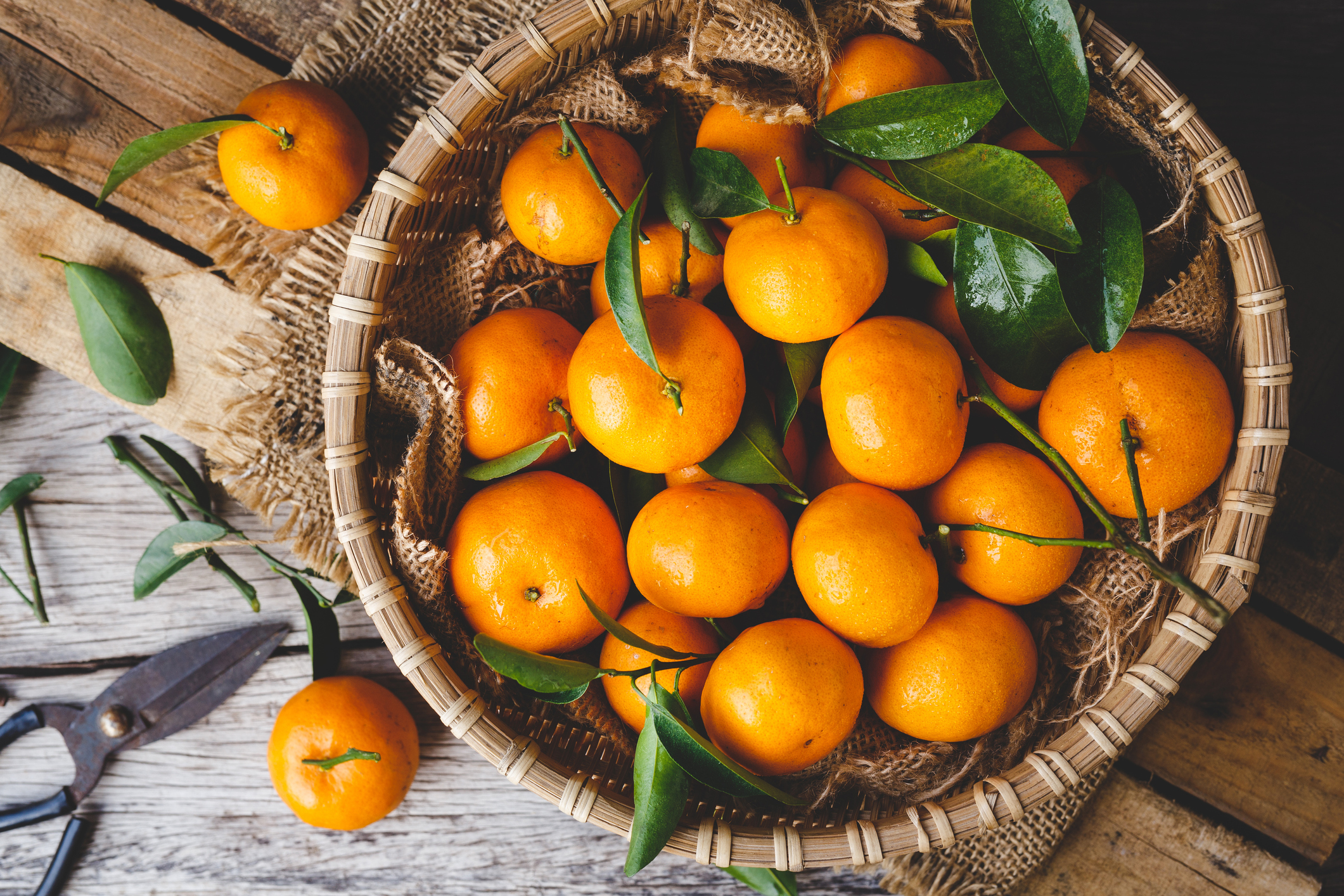 Above view of oranges In a basket on a table