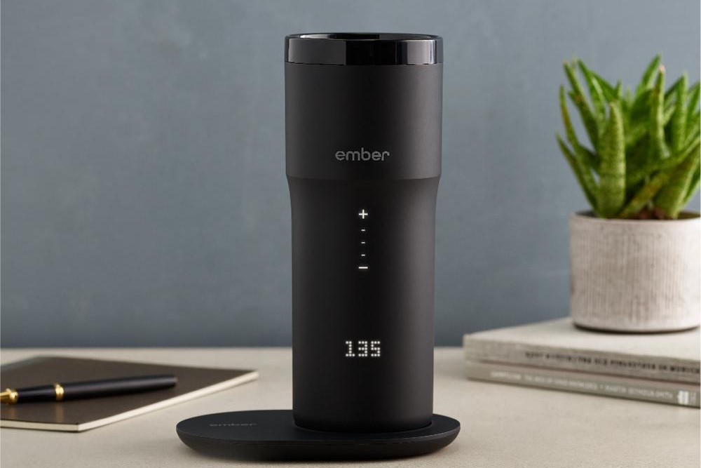 The Ember Travel Mug on a desk.