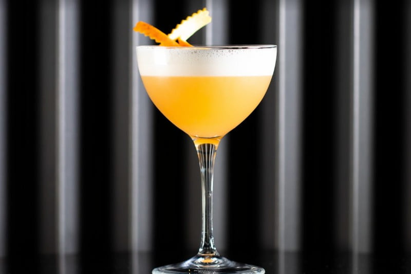 A glass of Veracruz cocktail with strips of orange peel