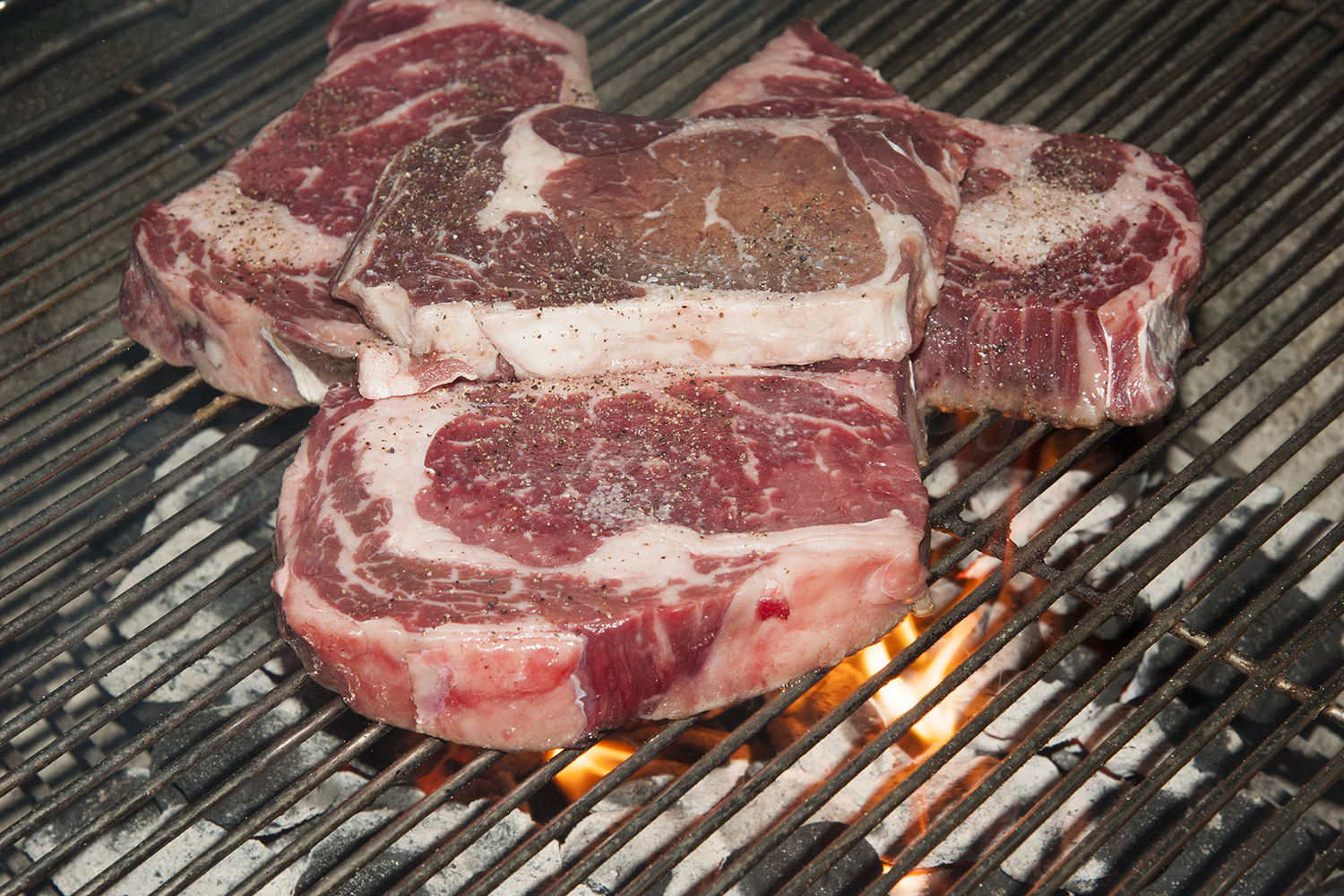 Rib-eye steaks on a barbecue