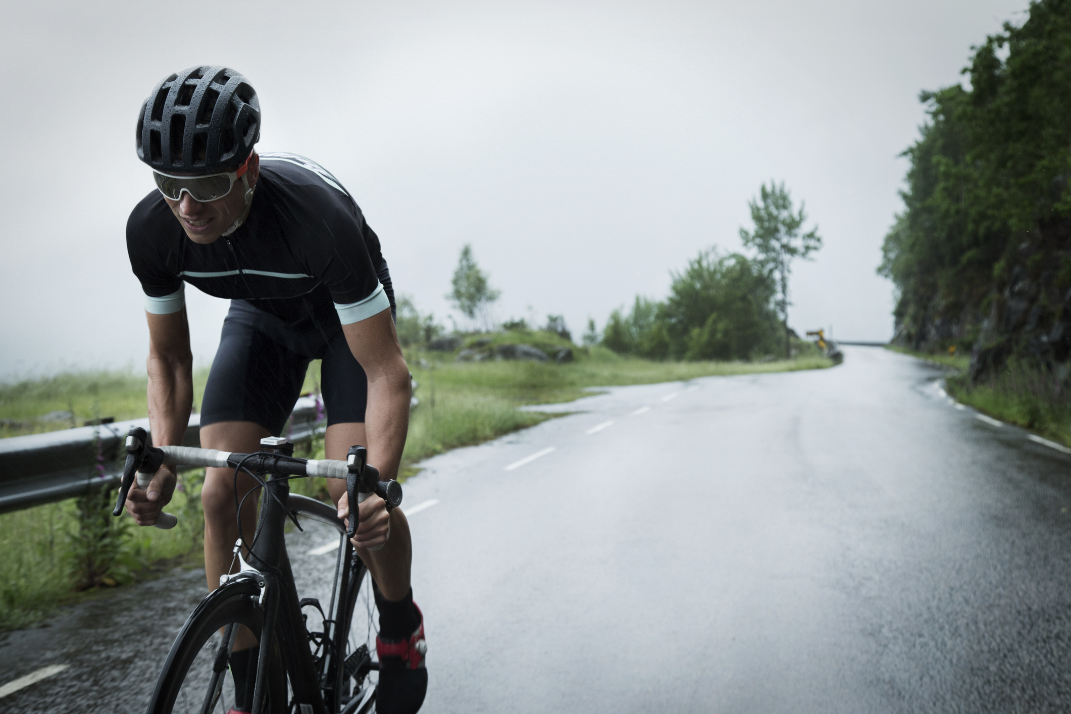 man cyclist driving up a mountain road