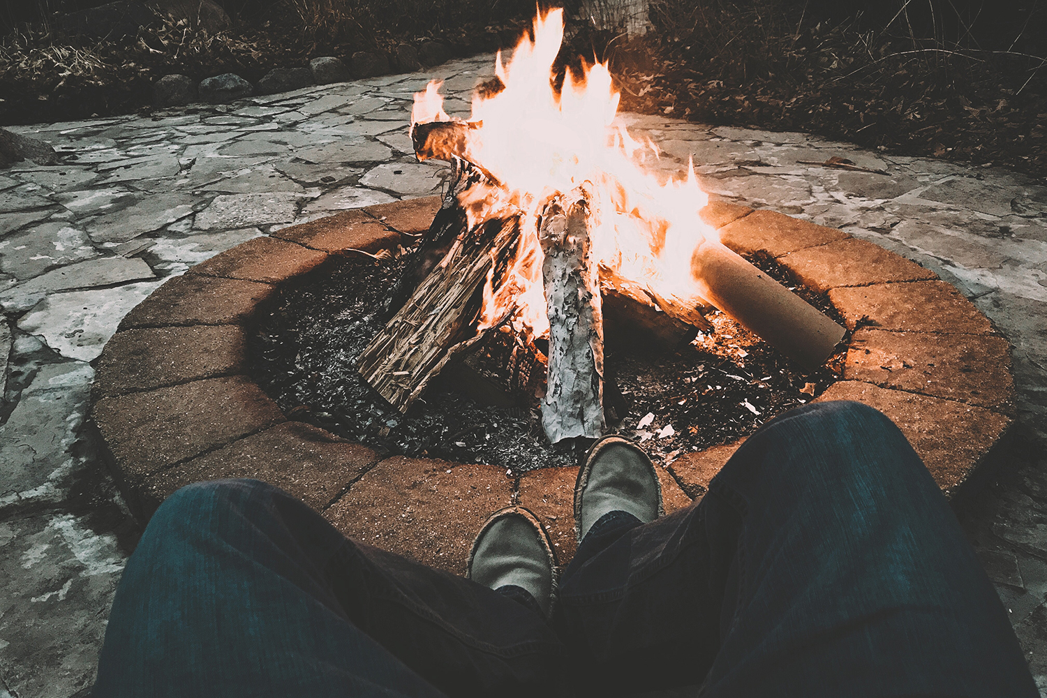 Man by burning fire In a pit