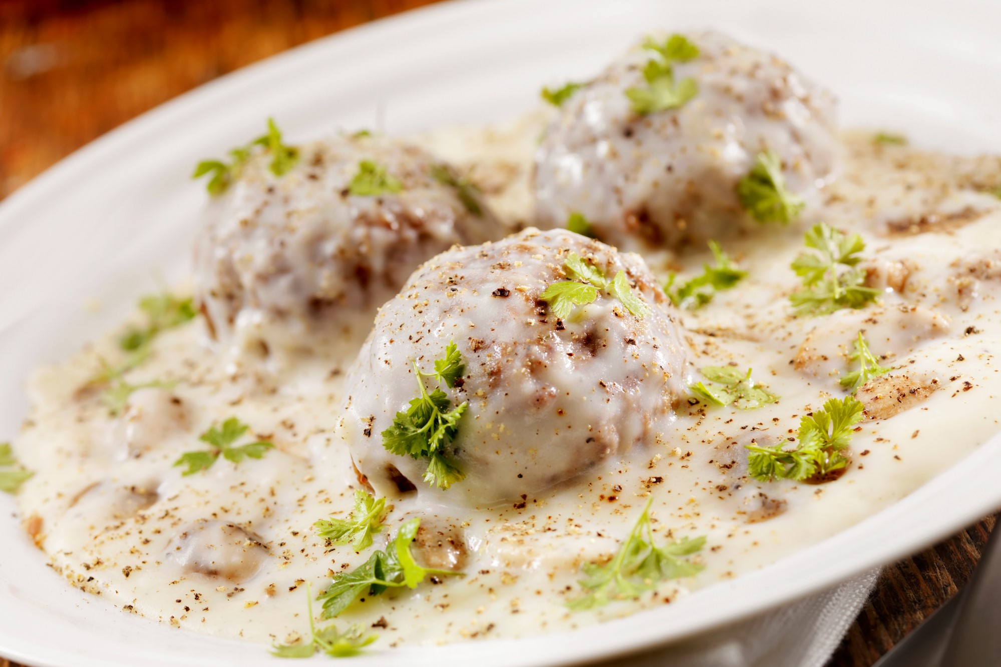 Meatballs in a mushroom béchamel sauce with fresh parsley