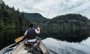 Person fishing from a canoe at Buntzen Lake in British Columbia, Canada.