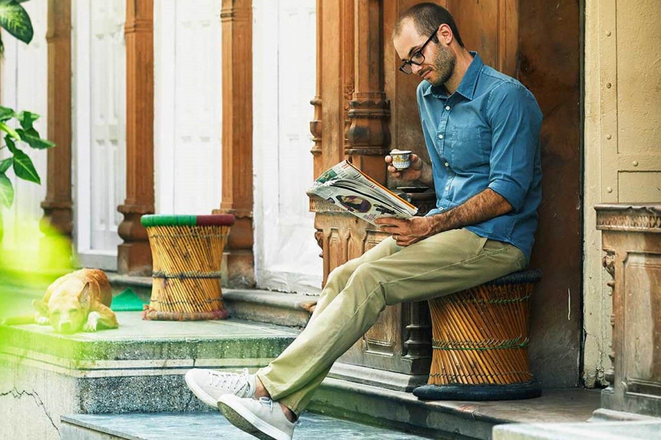 Man reading a paper outside his vacation rental