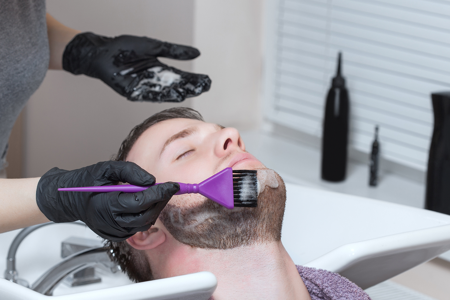 Man having beard dye applied to beard