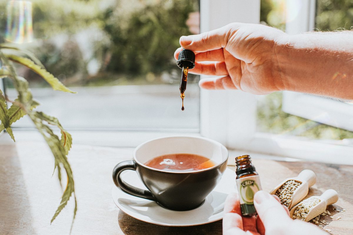 Adding CBD oil to a cup of tea