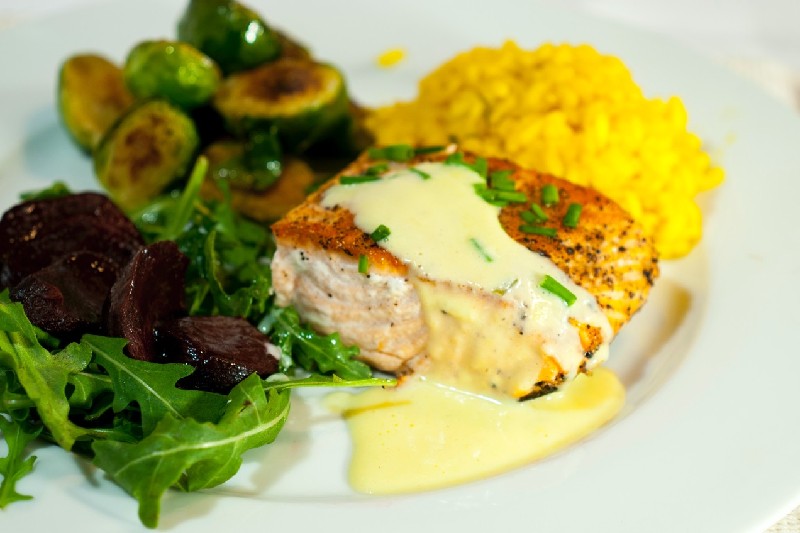 Vegetable on a plate with grilled salmon with hollandaise sauce