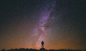 person standing under night sky