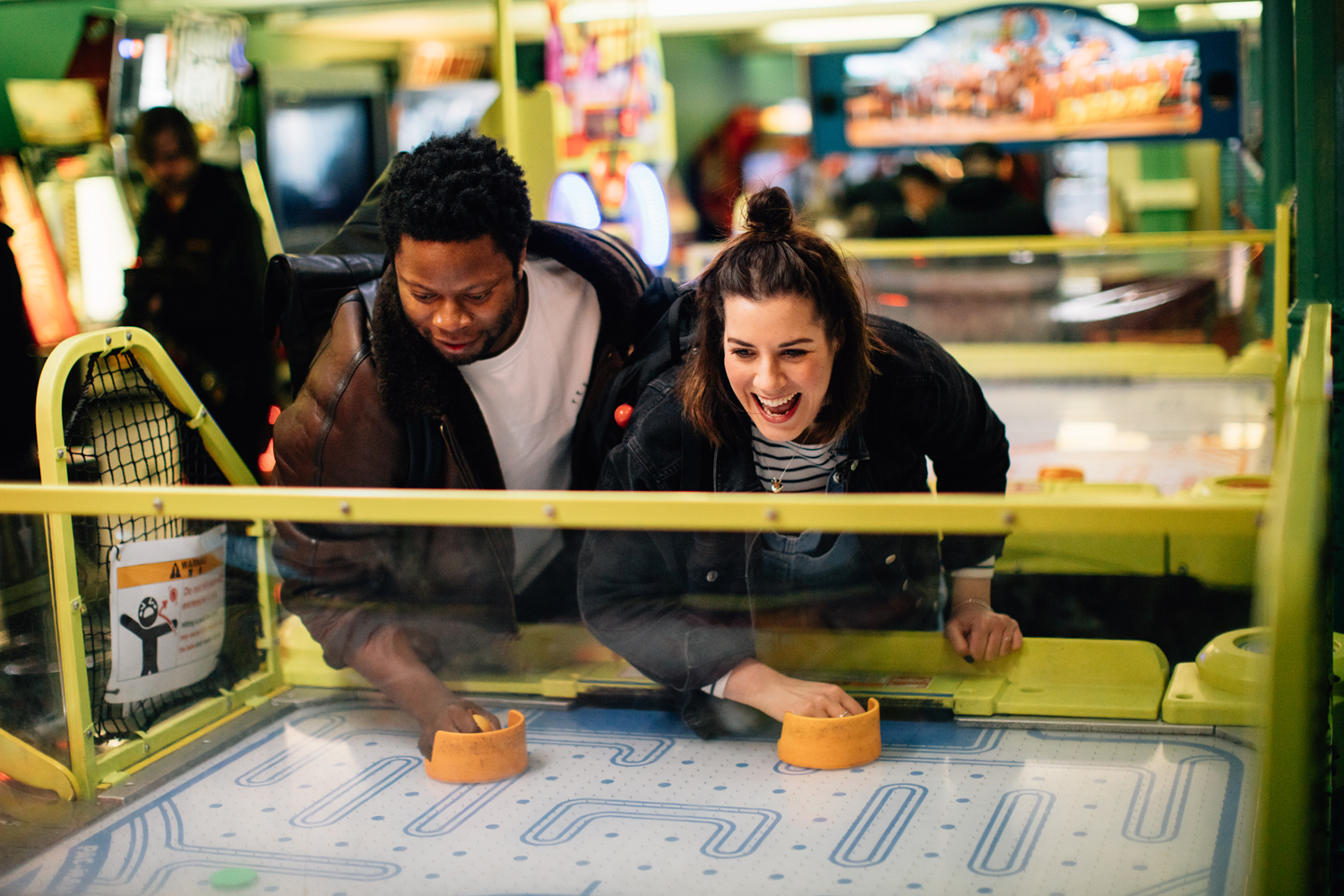 A couple enjoying an arcade game