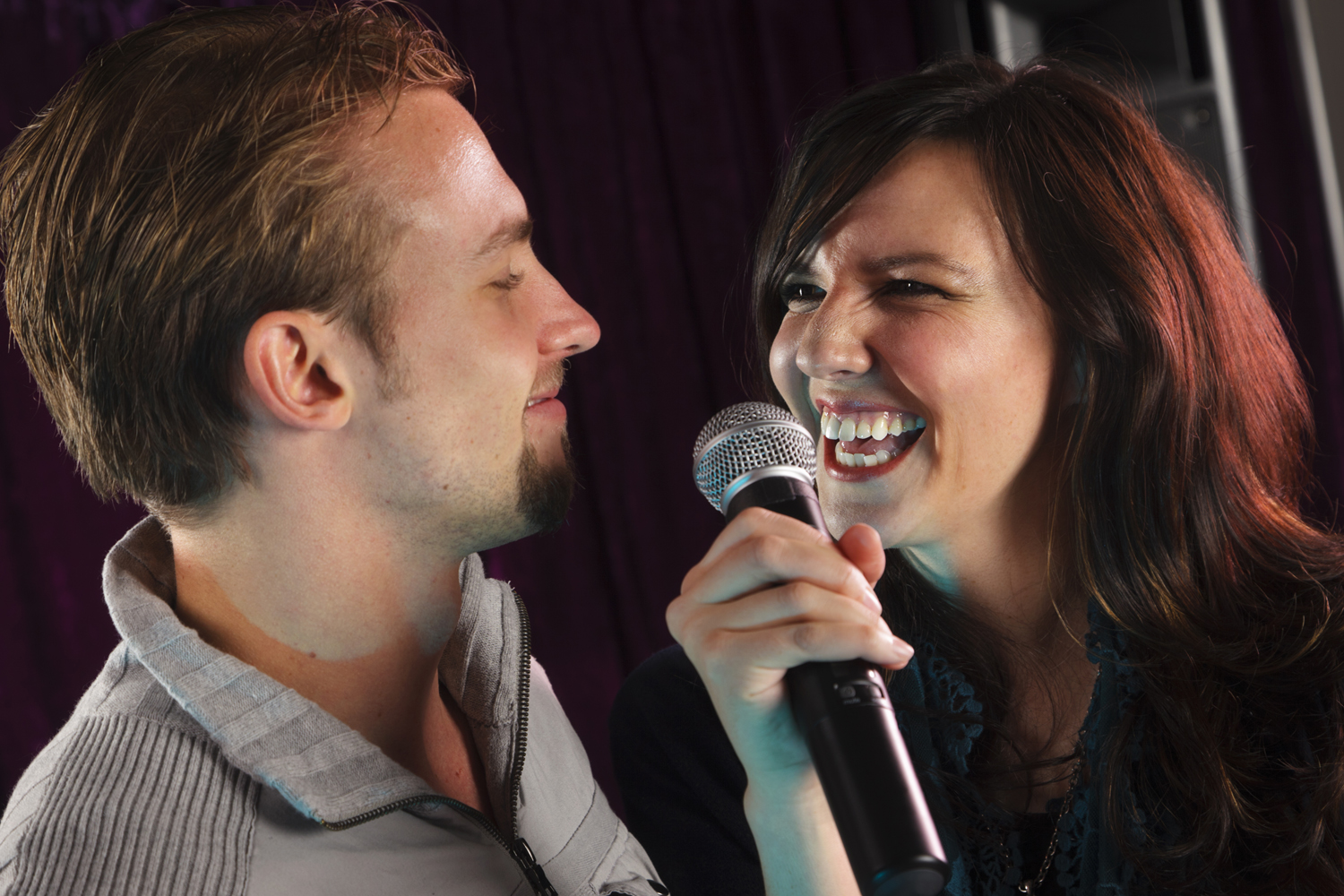 A man and a woman singing karaoke.