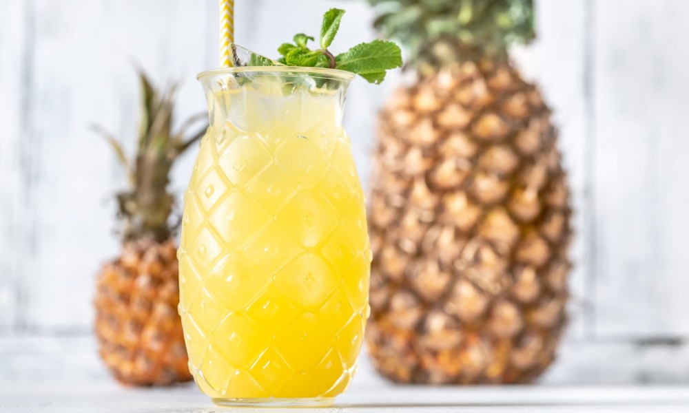 A glass of pineapple Tiki style cocktail.