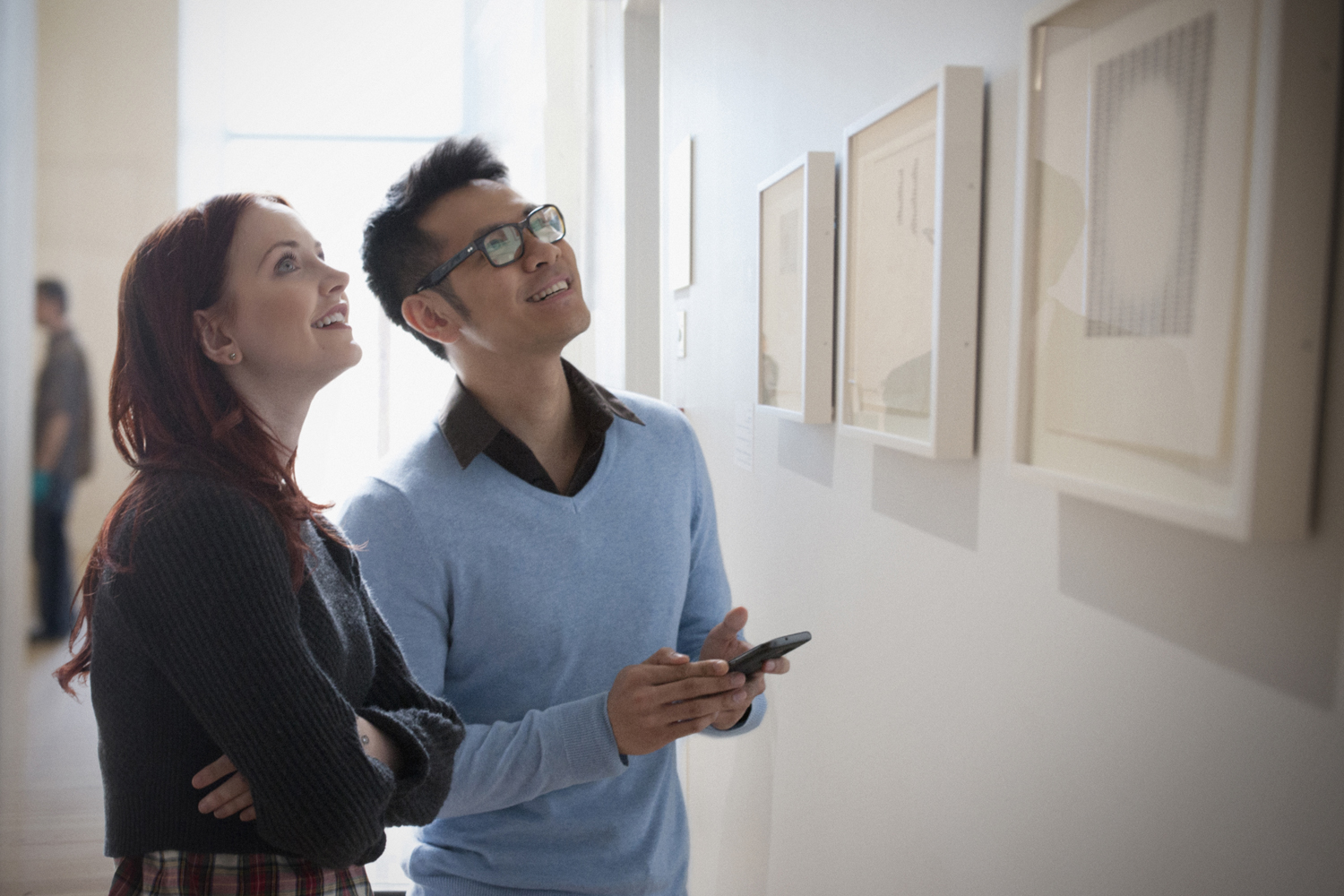 A couple admiring artwork in an art gallery.