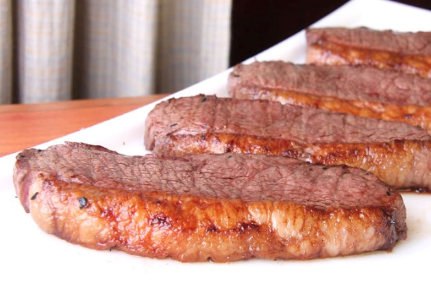 Scrumptious baby beef served on a white plate.