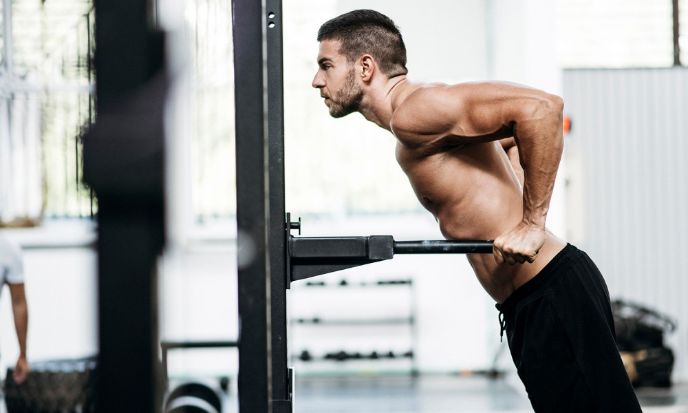 Man doing a dip at the gym.