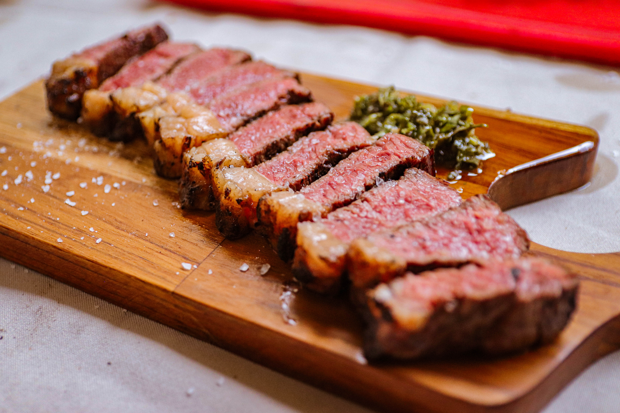 Barbecue picanha meat cut on wooden board.