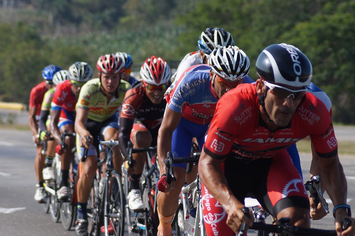 Peloton of men cycling on the road