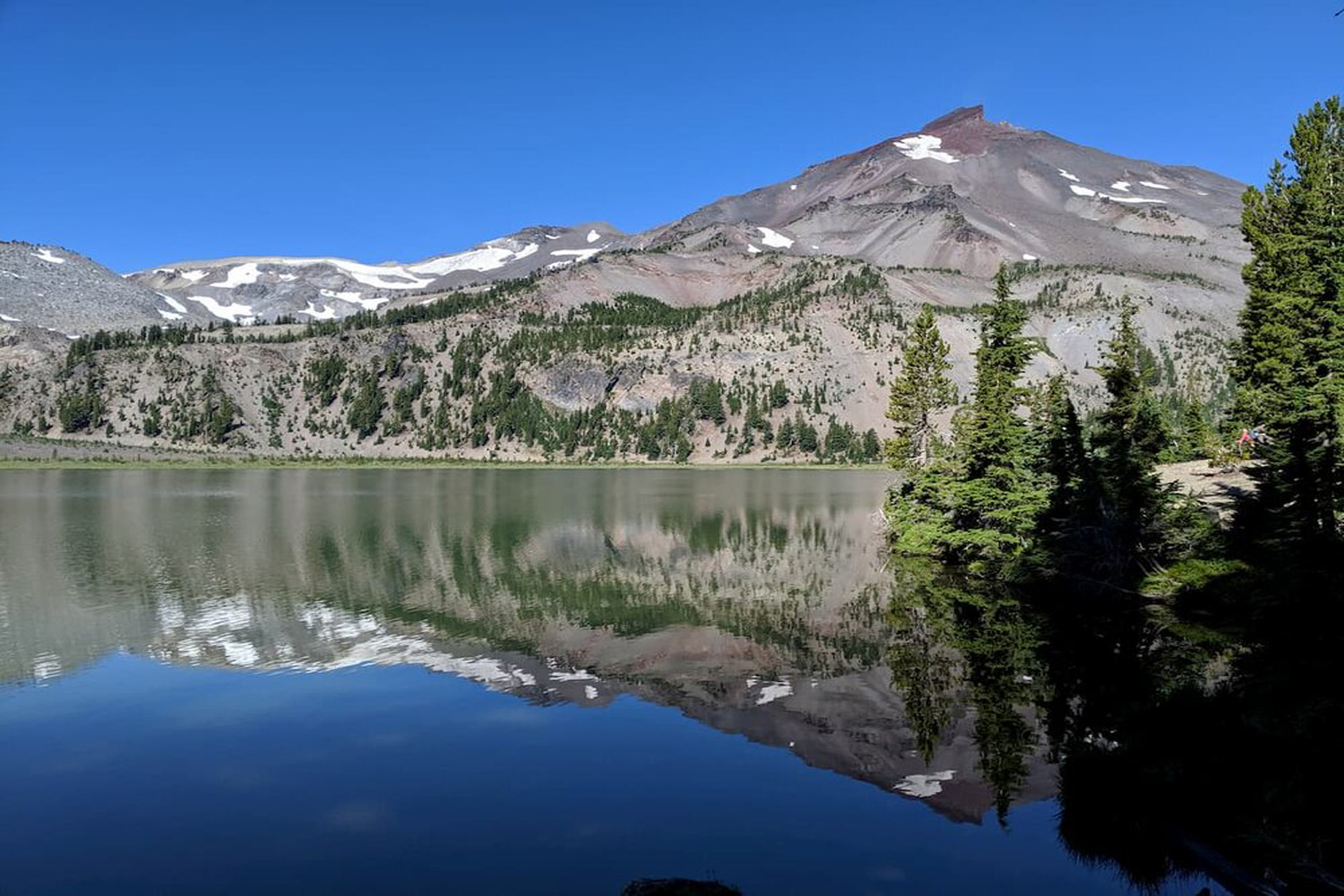 A pristine reflection of South Sister in Green Lake at day.