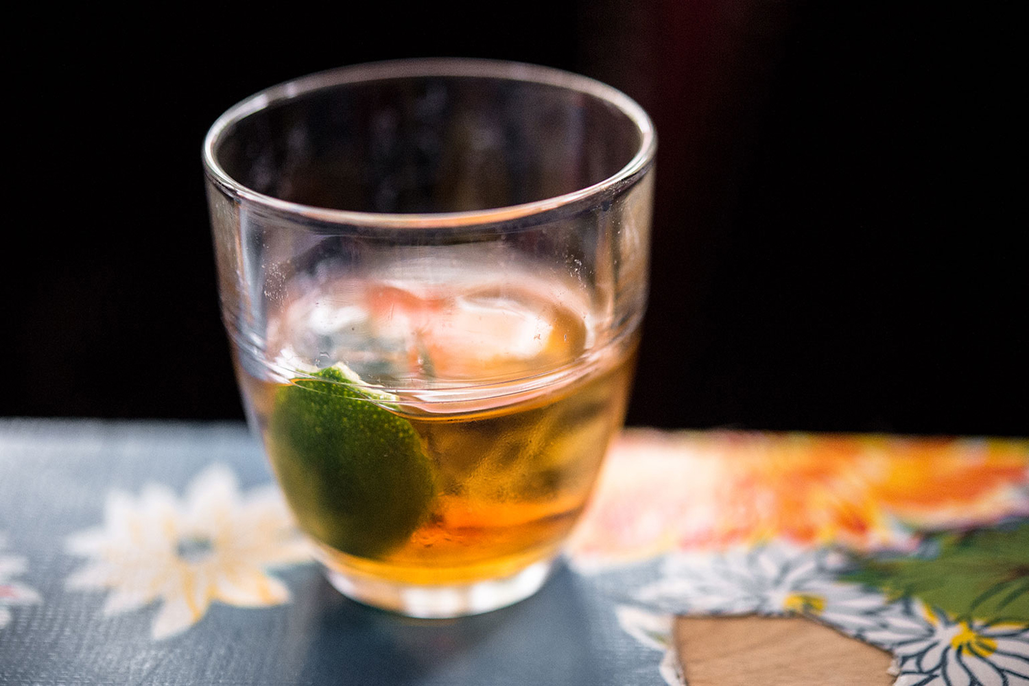 A cup of Ti-Punch on a floral tablecloth