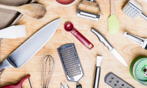 Assorted kitchen utensils on a wooden table.