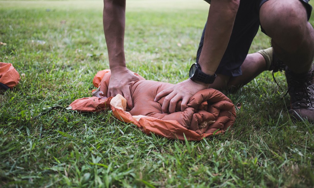 Man rolling tent.