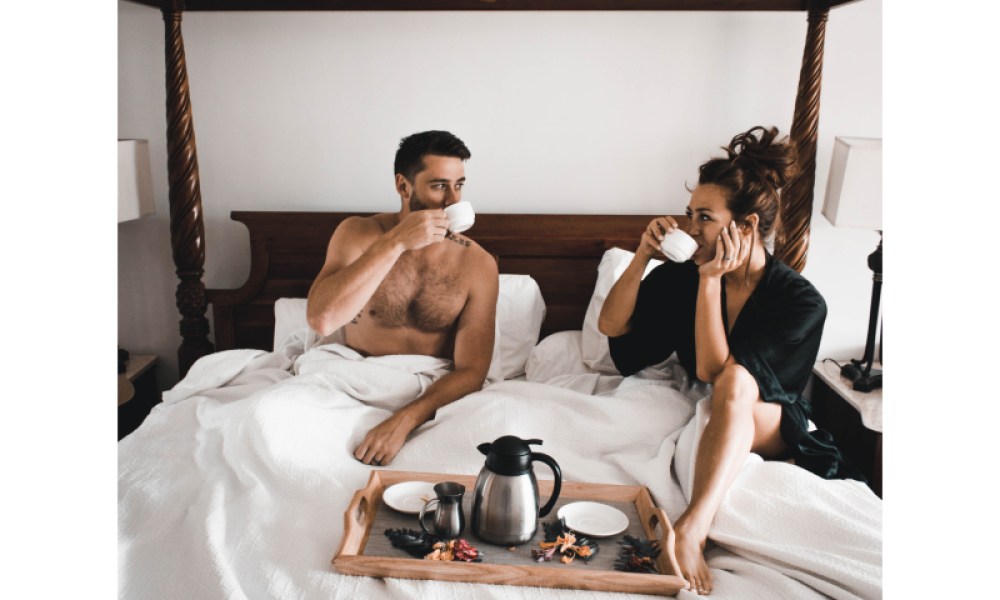 A couple having breakfast in bed.