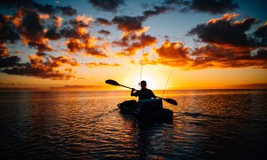 In a fishing kayak at sunset