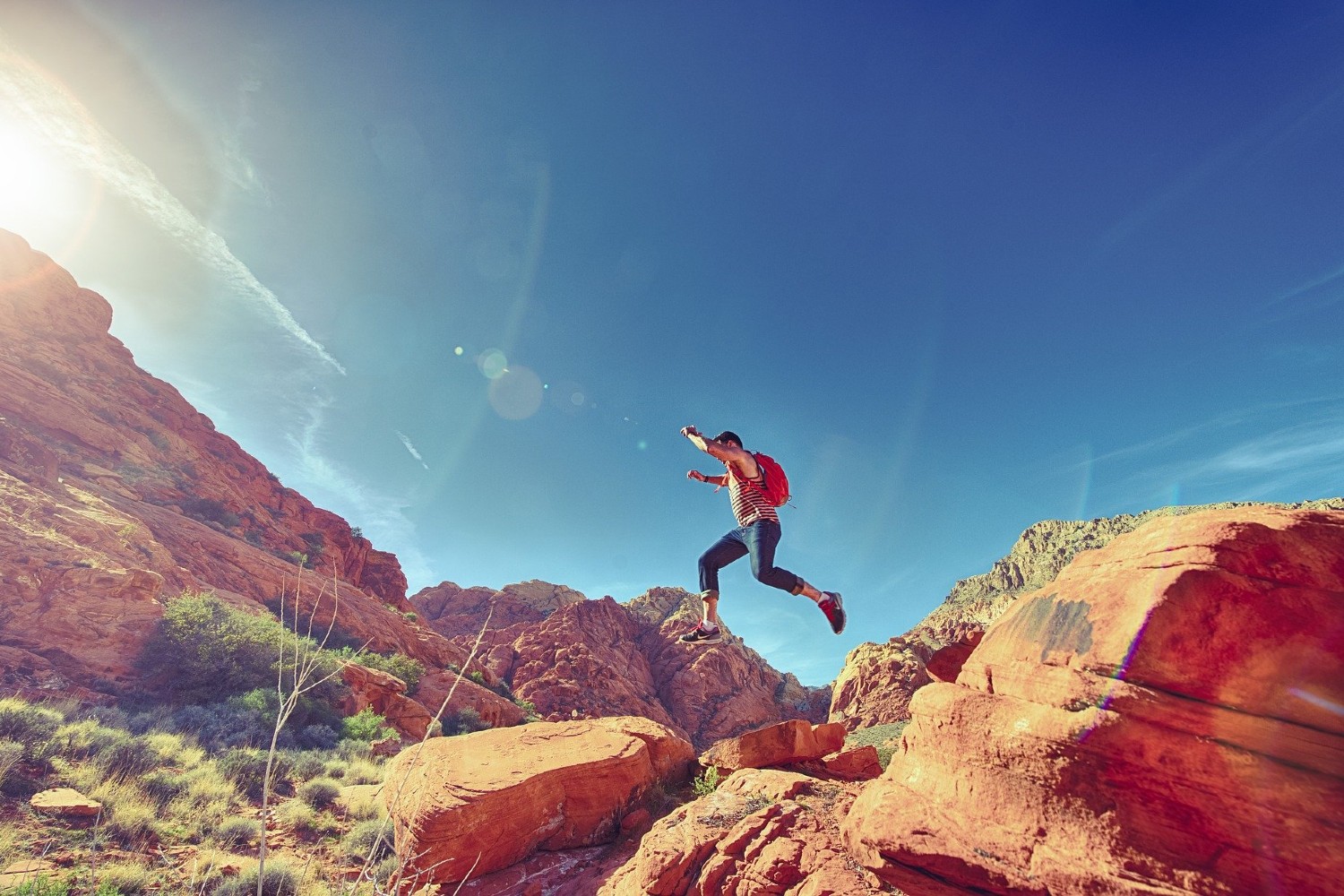 Hiker jumping rocks on a warm day