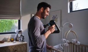 Theragun Elite massage device used by new Dad in nursery!