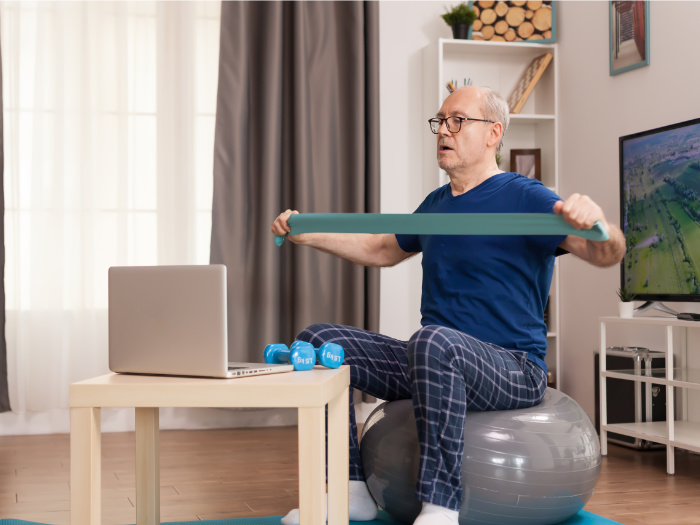 Training online with resistance band on exercise ball.