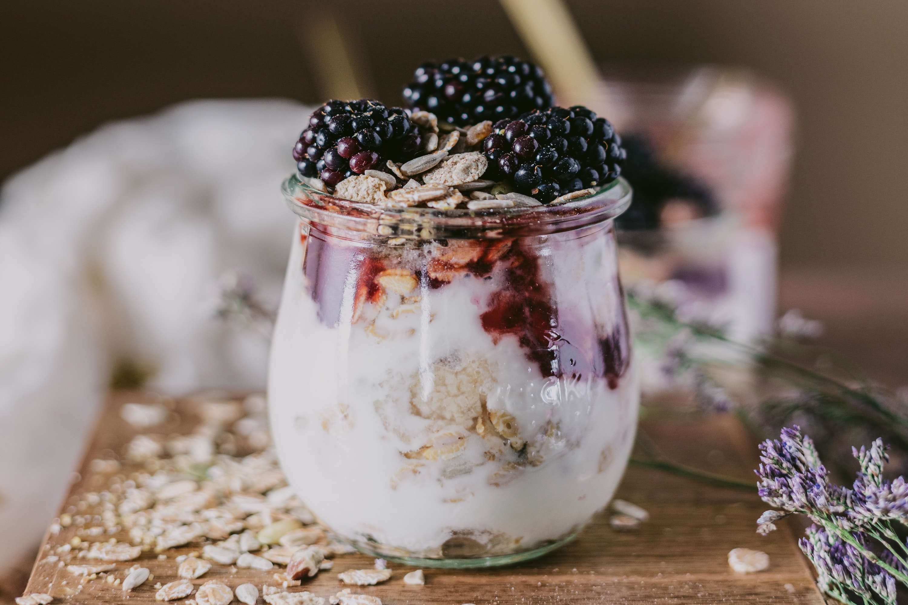 Overnight oats in a jar with yogurt and blackberries.