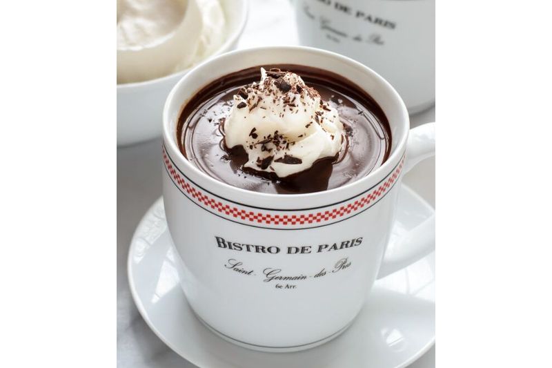 mug of hot chocolate sitting on a saucer.